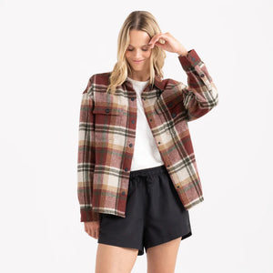 Woman wearing a plaid jacket and black shorts on a white background shacket