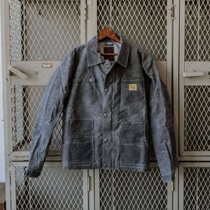 Waxed denim Bradley Mountain jacket hung on gray lockers 