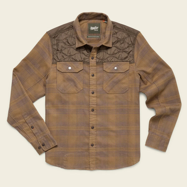 Brown plaid shirt with quilted accents on a beige background